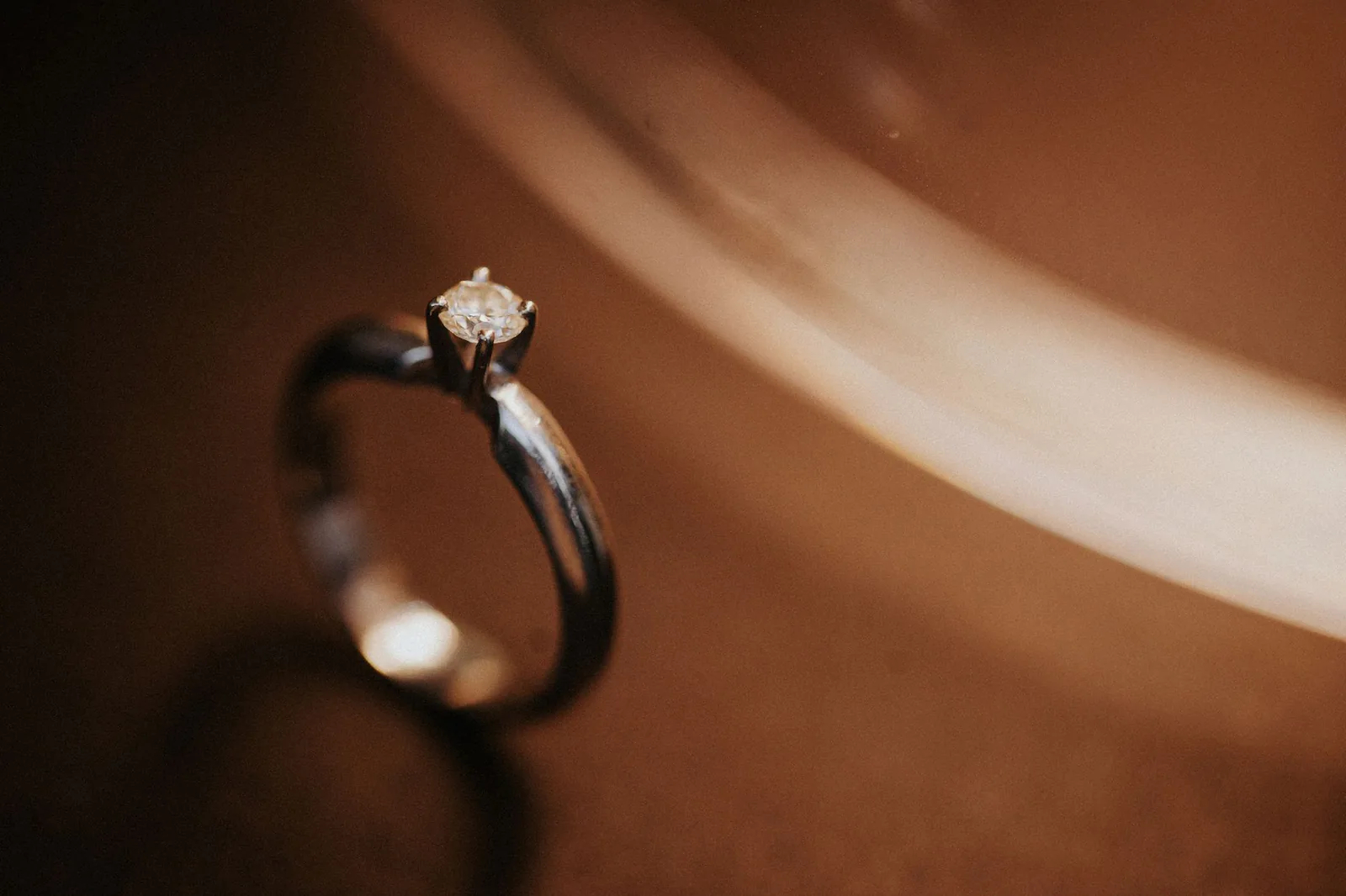 Diamond engagement ring in warm moody light