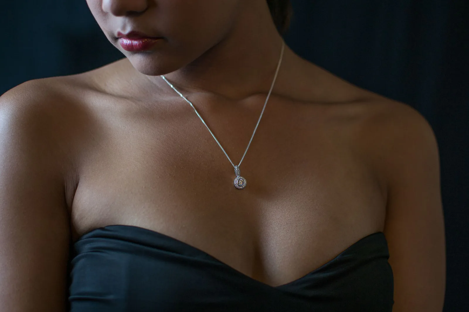 Woman in a black dress wearing a diamond necklace