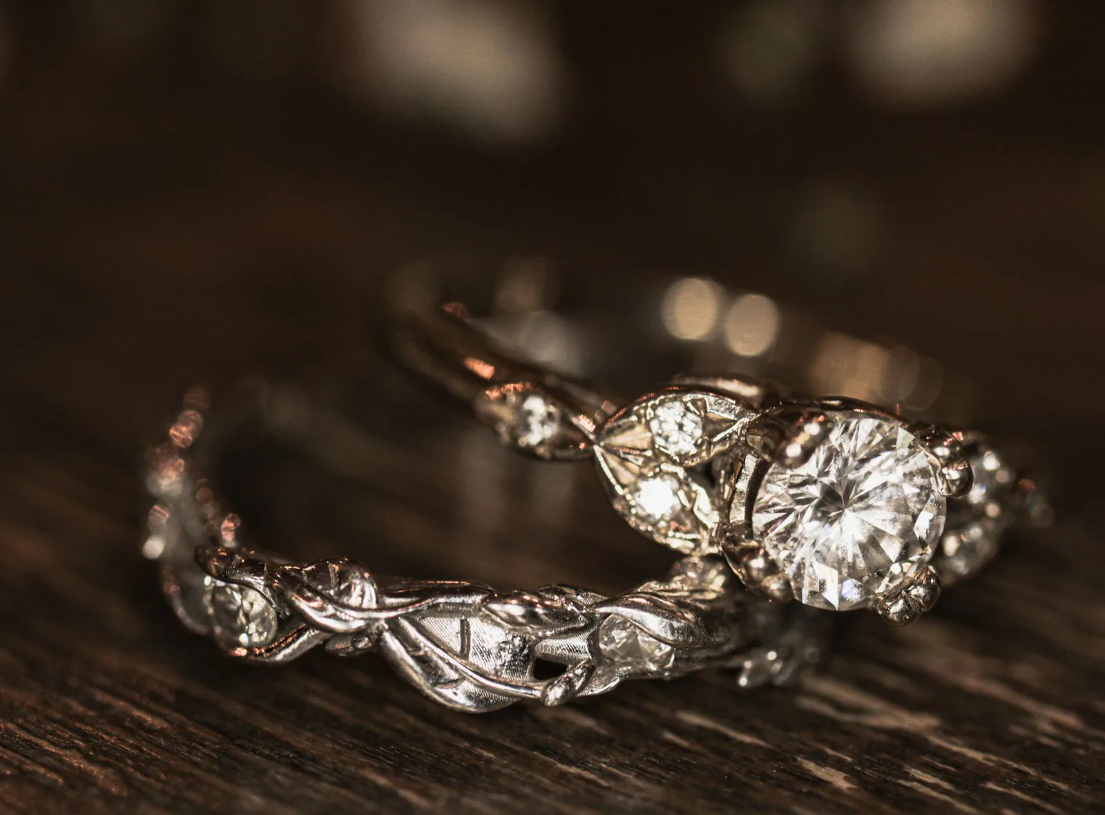 Engagement and wedding rings on a wooden surface