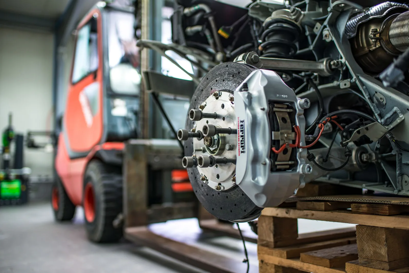 Brake caliper and rotor on a vehicle in the workshop