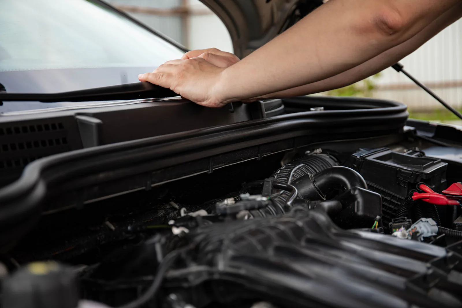 Hands performing mechanical engine repair