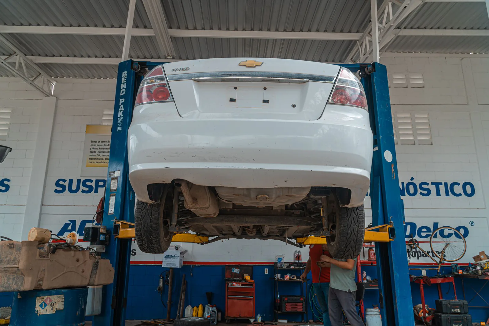 Vehicle raised on a lift for routine maintenance