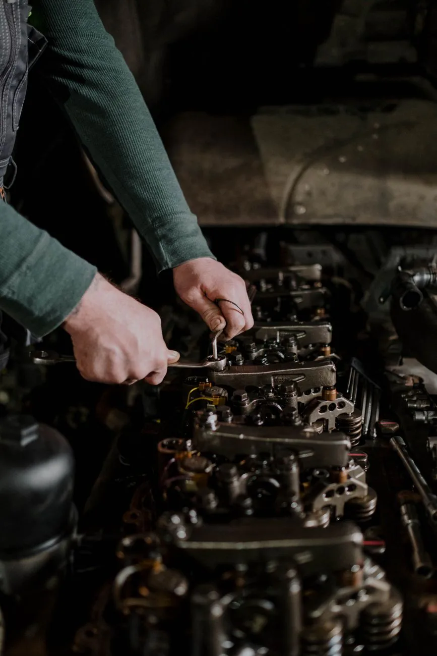 Hands using tools during an engine repair