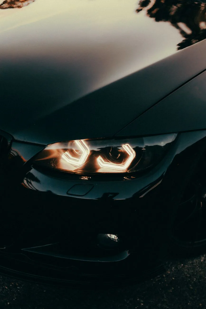 Headlights glowing in a dim workshop