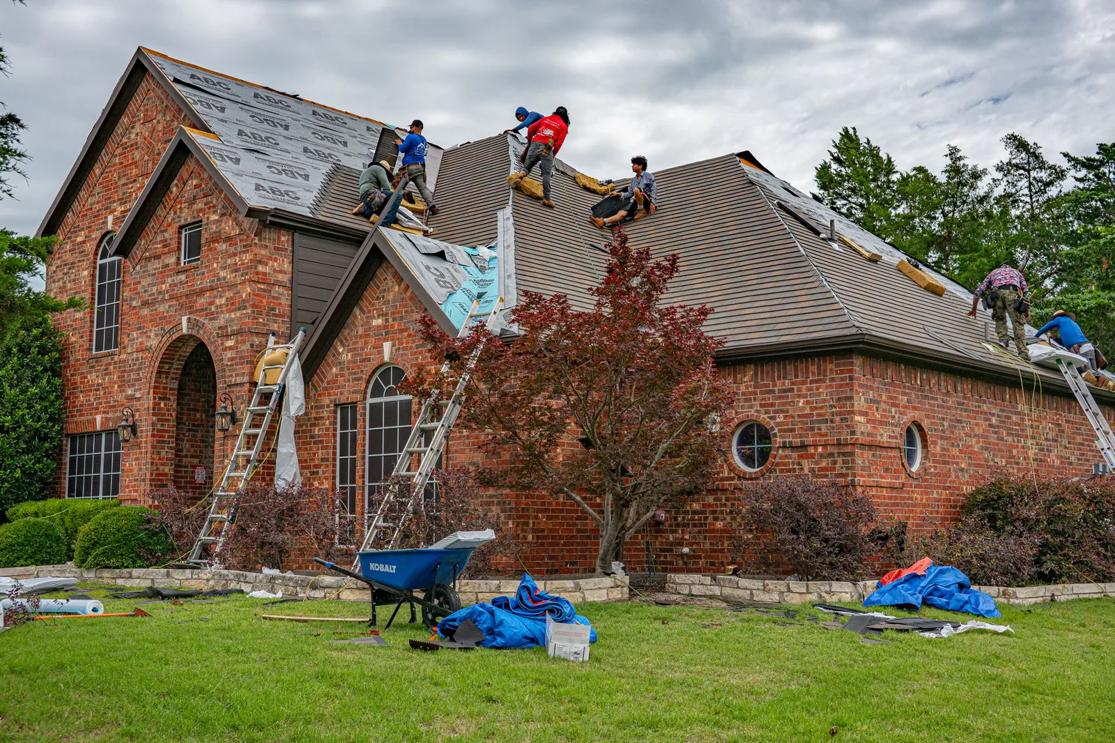 Roofing crew working on a residential home