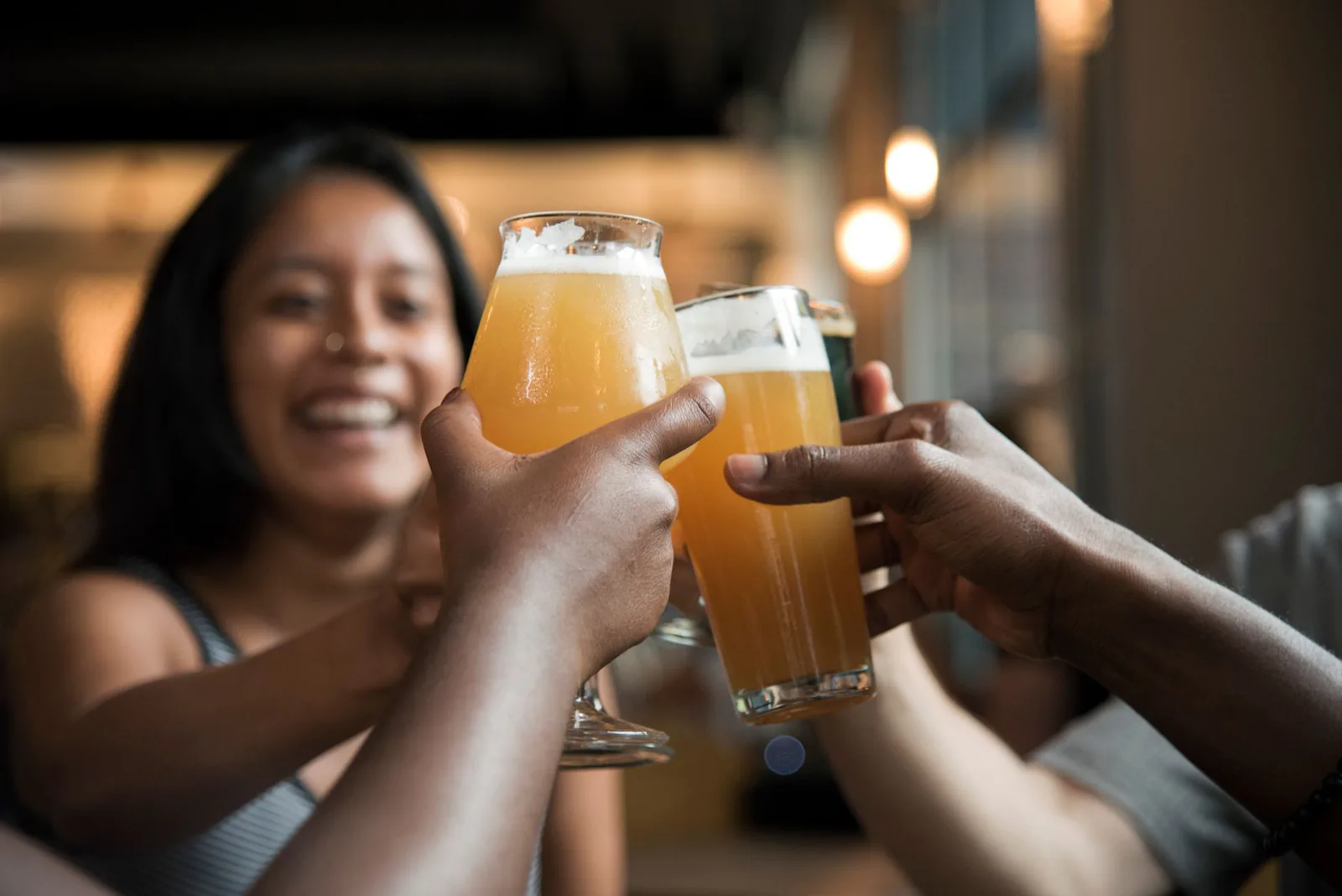 Friends toasting drinks together at Tribal