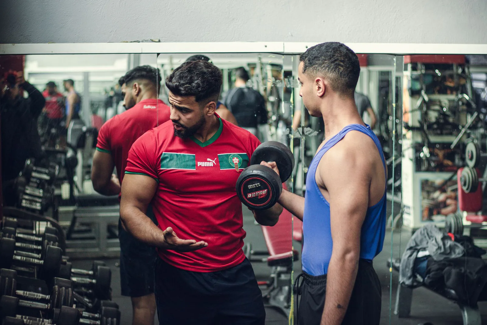 A trainer guiding a client through proper weight training technique