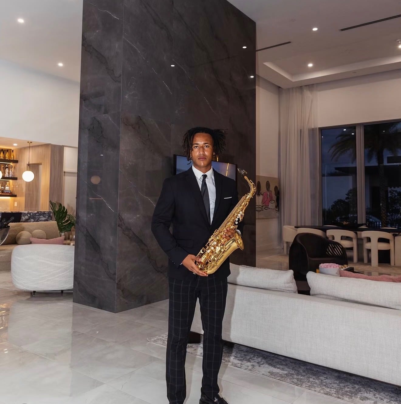 Saxophonist in a suit performing in a luxury hotel interior